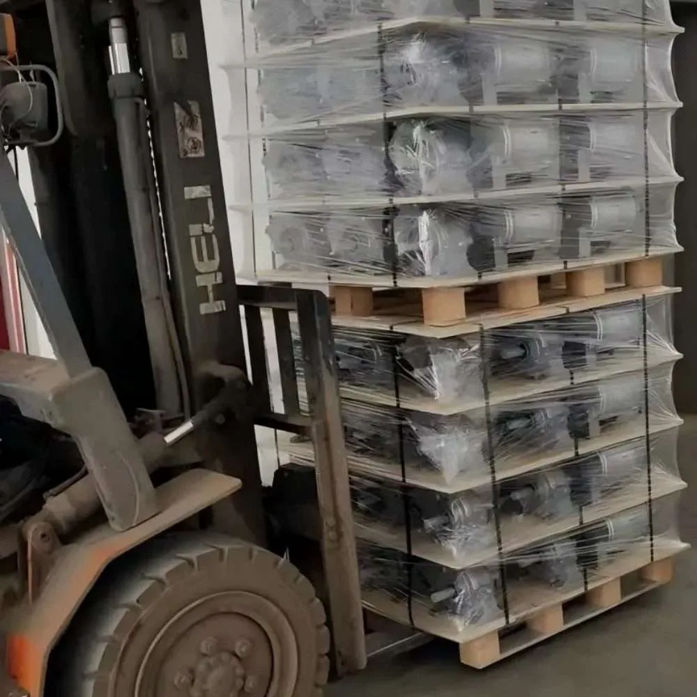 Forklift loading pallets of center pivot irrigation gearboxes into a container for international export.
