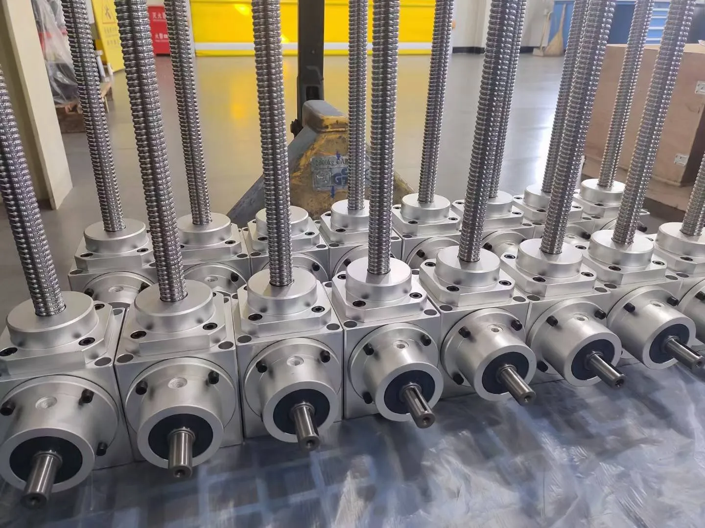 Massive batch of high-precision cubic screw jacks showing superior manufacturing finish.