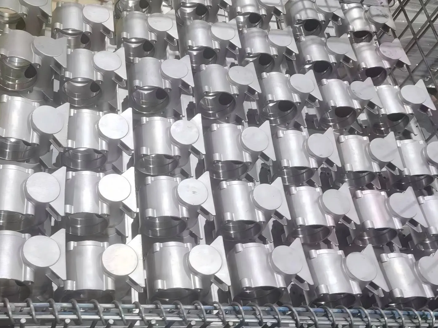 Large racks of premium stainless steel gearbox housings awaiting precision machining. Demonstrating reliable high-volume manufacturing capabilities.