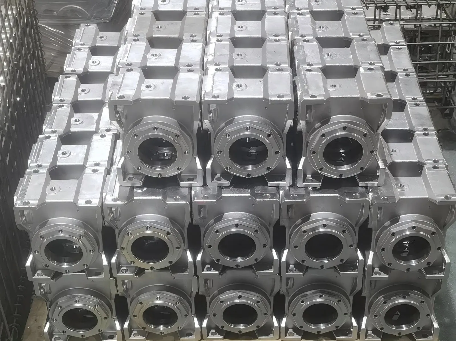 Neatly stacked food-grade stainless steel gearbox housings with smooth, easy-to-clean surfaces. Designed to prevent bacterial growth in processing lines.